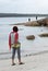 Woman on beach watching fishermen