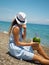 Woman on the beach with watermelon cocktail