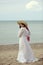 Woman at the beach wearing vintage dress