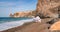 Woman beach white dress flying on Wind. Summer Vacation. A happy woman takes vacation photos to send to friends.