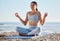 Woman, beach and yoga meditation for mind, body and spiritual wellness in summer sunshine. Girl, fitness or training for