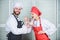 Woman and bearded man cooking together. Couple compete in culinary. Try ingredients before cook. Estimate taste. Healthy