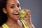 Woman beating apple with white teeth, close up