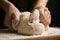 Woman beating dough at table. Making pasta