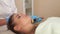 Woman at the beautician. Doctor uses microneedle mesotherapy roller.