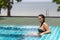 Woman beautiful breast in swimming pool on beach