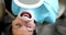 Woman with beautiful even teeth with retractor lying at dentist appointment 4k movie slow motion