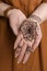 Woman with beautiful henna tattoo on hand, closeup. Traditional mehndi