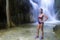 Woman beautiful stand relax in waterfall with bikini