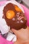 Woman in beauty salon with a chocolate face mask