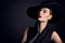 Woman Beauty in wide brim Hat, Elegant Fashion Model Retro Portrait on Black