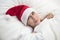 Woman in bed with Santa hat