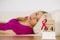 Woman on bed, world breast cancer day on calendar