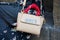 Woman with beige leather bag with `Cute` writing and red bandana before Les Hommes fashion show, Milan Fashion