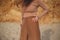 Woman in beige posing on the beach. hands closeup