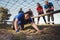 Woman being cheered bye her teammates during obstacle course training