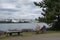 A Woman on a bench sitting alone. Bridge and Lake background.