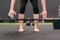 Woman bending over preparing to lift a barbell