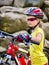 Woman on bicycle ride mountain. Girl traveling in summer park.