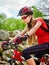 Woman on bicycle ride mountain. Girl traveling in summer park.