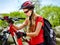 Woman on bicycle ride mountain. Girl traveling in summer park.