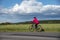 Woman bicycling in summer in Finland