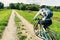 Woman bicyclists riding on country road.