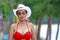 Woman big breast with red bikini and hat on beach