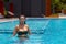 Woman big breast in swimming pool on beach