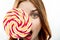 woman with big multicolored round face lollipop sweet candy close-up