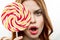 woman with big multicolored round face lollipop sweet candy close-up