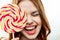 woman with big multicolored round face lollipop sweet candy close-up