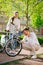 Woman with bike and man looking wheel