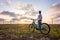 Woman with a bike in the nature