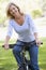 Woman on bike outdoors smiling