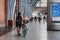 Woman with a bike walking inside St. Pancras Station, London, UK.