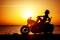 Woman biker enjoying sunset