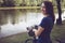 Woman biker in park with water reflection