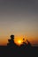 Woman biker silhouette over sunset, female riding motorcycle, motorbike driver traveling, lady look on the beach, freedom