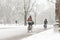 Woman biking in a snowy Amsterdam Vondelpark.