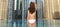 Woman in bikini from back over dubai city pool