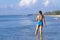 Woman with bikini blue pretty jump on wave at beach