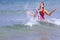 Woman with bikini crimson happy wave on beach