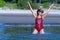 Woman with bikini crimson and hat happy on beach