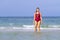 Woman with bikini crimson show beautiful on beach