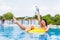 woman in bikini enjoying summer sun and tanning during holidays in pool with cocktail. Top view. Woman in swimming pool.