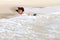 Woman with bikini and hat happy wave on beach