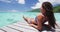 Woman in bikini at Luxury travel vacation destination on overwater bungalow villa deck at Tahiti resort tropical holiday