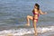 Woman with bikini pink happy exercise on beach