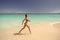Woman in bikini run on beach in antigua